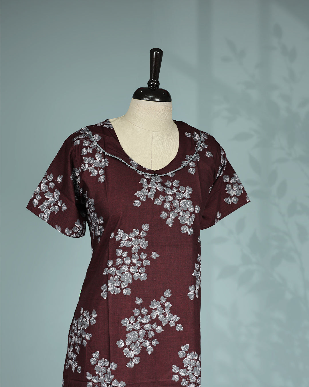 Maroon floral kodi  printed nighty with a classic scoop neckline, short sleeves, delicate lace trim detailing along the neckline, and a relaxed midi-length for everyday comfort and effortless elegance.