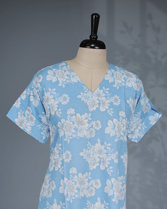 Sky Blue colour nighty featuring white floral prints on body , a V-neckline, short sleeves, and a ruffled mid-length fit.