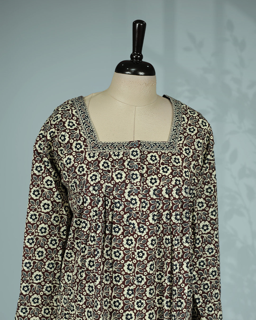 Brown & cream floral printed nighty with an elegant square neckline full sleeves, delicate printed border detailing, front button placket and a graceful full-length fit.