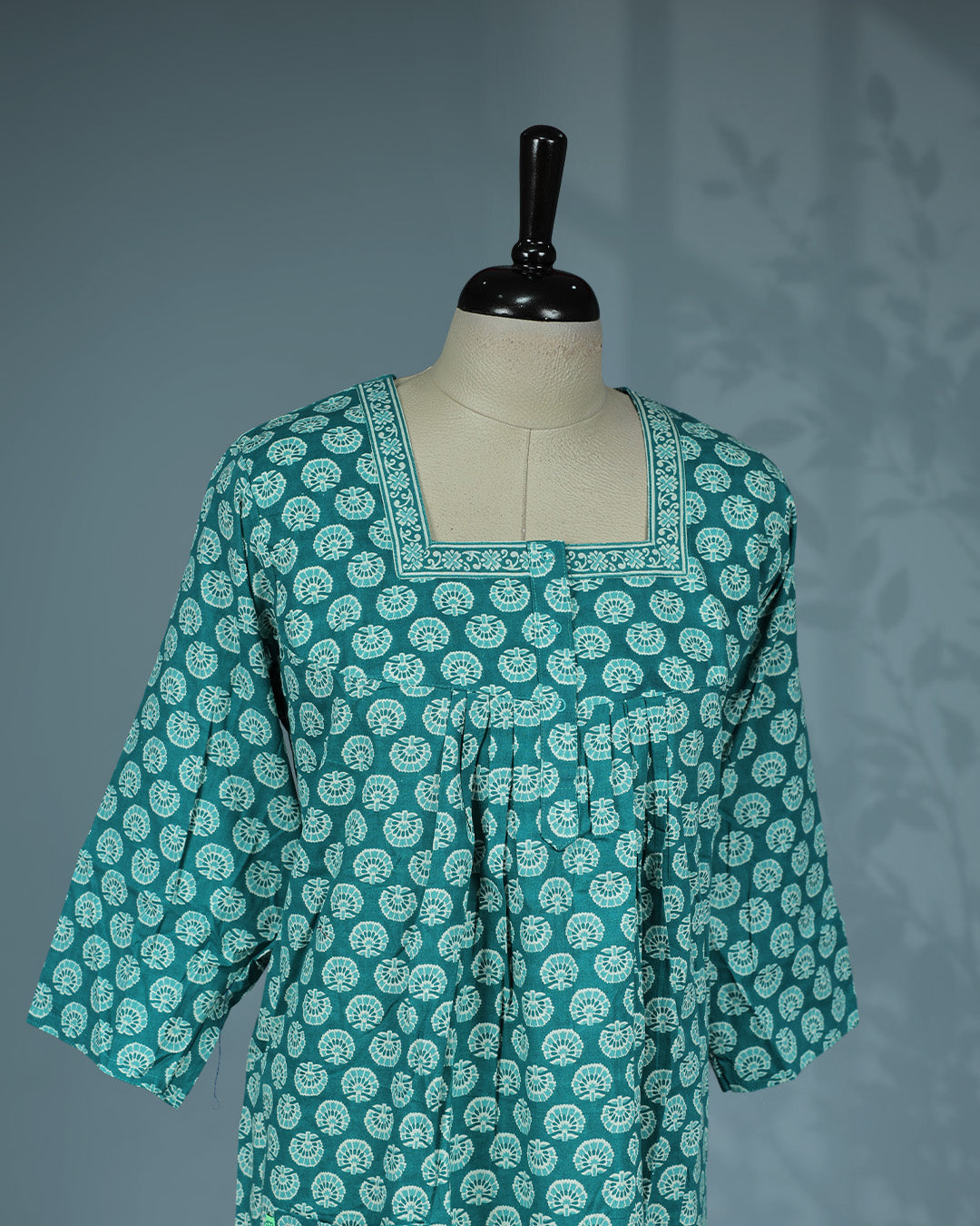 Teal colour printed nighty featuring a square neckline with contrast printed border & three-quarter and a comfortable full-length relaxed fit for everyday elegance and all-night comfort.
