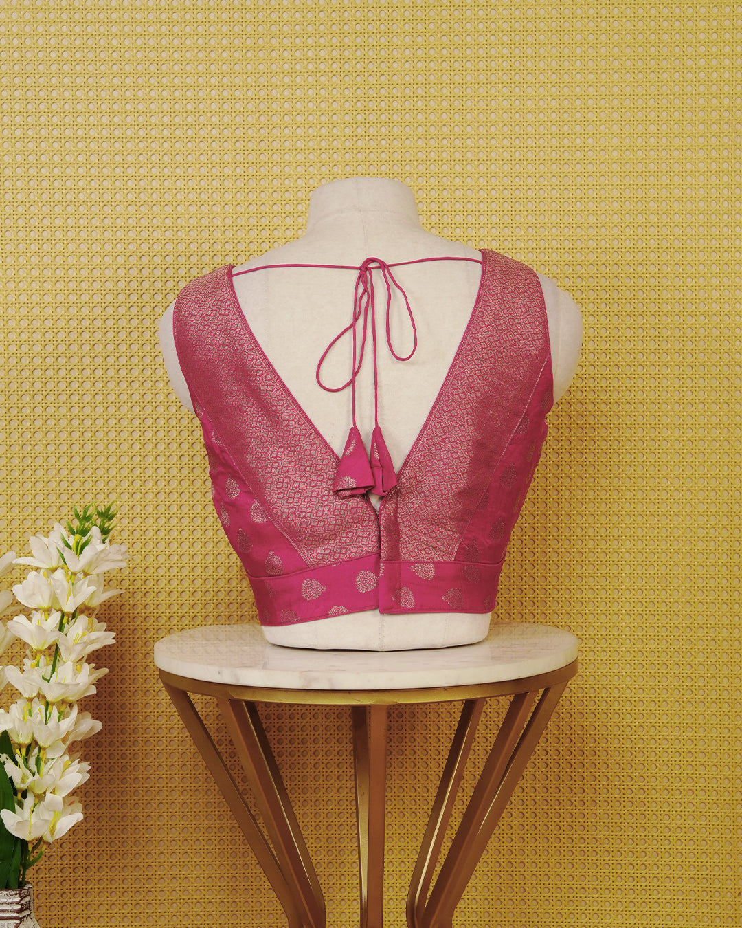 Pink colour Sleeveless Blouse Featuring A Stylish V-Neck, Elegant Woven Pattern With Gold Butta Motifs, And A Comfortable Tailored Fit.