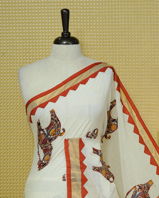 Cream colour Kerala saree Featuring Ajrakh Inspired Buttas Red Horse pattern, Gold zari border, comes with matching blouse piece.