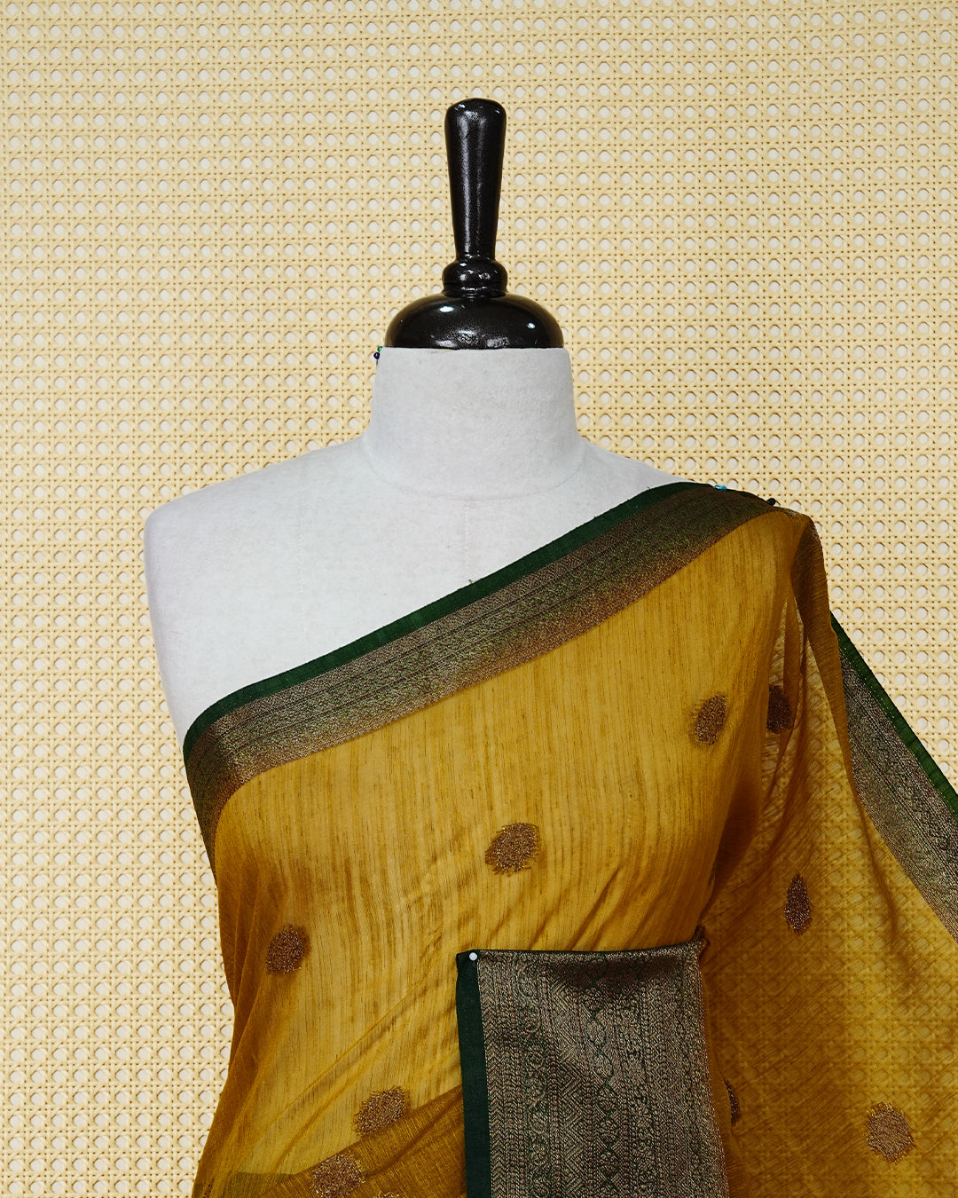 Mustard yellow colour semi linen saree thread motifs on body, contrast Dark green colour gold zari border, rich pallu comes with matching blouse piece