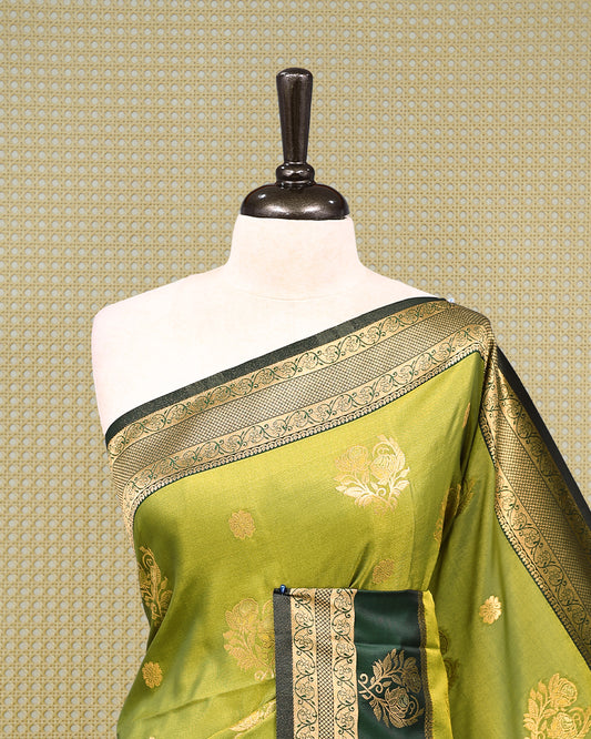 Olive green & gold double shade Mulberry silk saree featuring floral gold zari patterns on body, paired with contrast forest green colour with traditional border, comes with matching blouse piece.