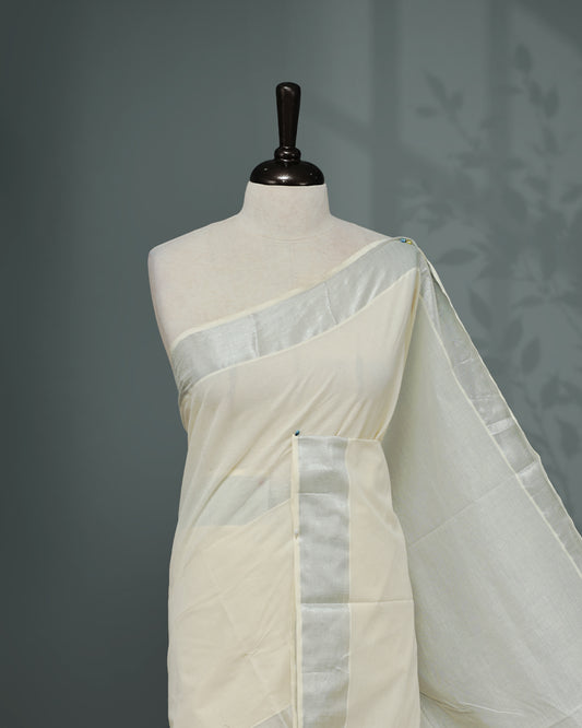 Cream colour Kerala saree Featuring an Elegant plain body, complemented by a classic Silver & Rose gold zari border, matching blouse piece.