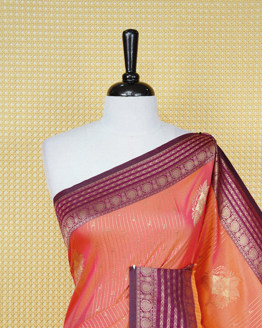 Rust orange & gold double shade Mulberry silk saree featuring floral gold zari patterns on body, paired with contrast purple colour with traditional border, comes with matching blouse piece.