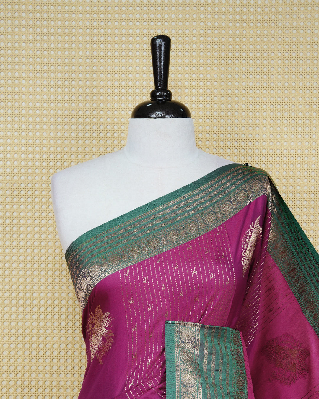 Purple colour Mulberry silk saree featuring gold floral zari patterns on body, paired with contrast green colour with traditional border, comes with matching blouse piece.