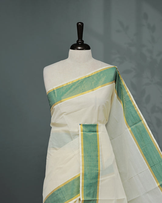 Cream colour Kerala saree Featuring an Elegant plain body, complemented by a classic gold & Green zari border, matching blouse piece.