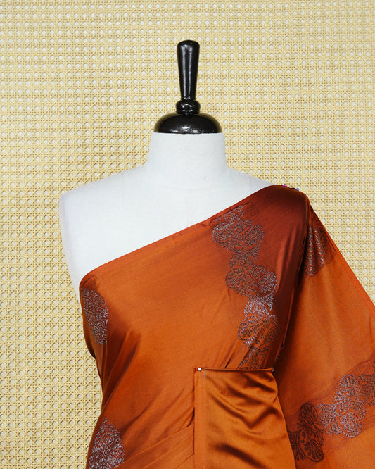 Rust orange colour soft silk saree featuring antique zari motifs on body with contrast self colour pallu & paired with matching blouse piece.