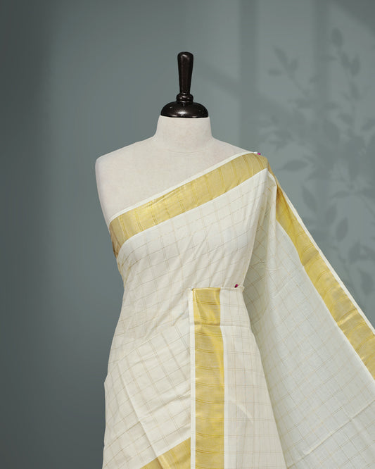 Cream colour Kerala saree Featuring Gold zari Checks on the body, complemented by a classic gold zari border, matching blouse piece.
