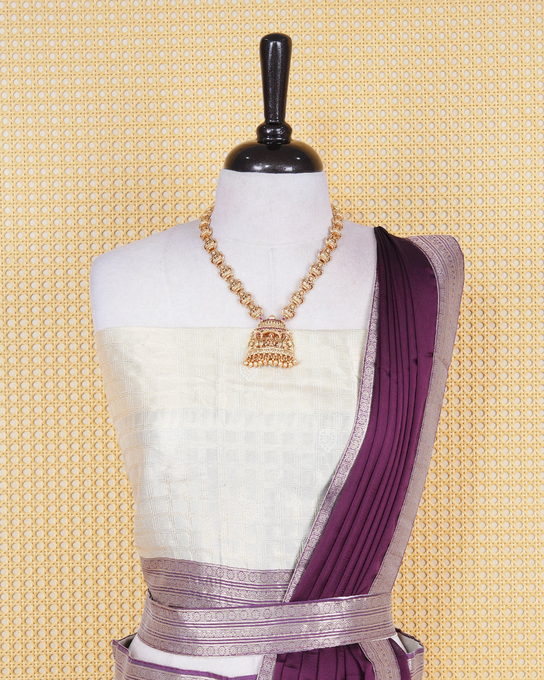 Cream colour tissue Semi stitched dhavani set featuring Gold zari check pattern with motifs on body ,contrast Purple colour with gold zari bordered skirt, paired with matching blouse piece & dupatta.