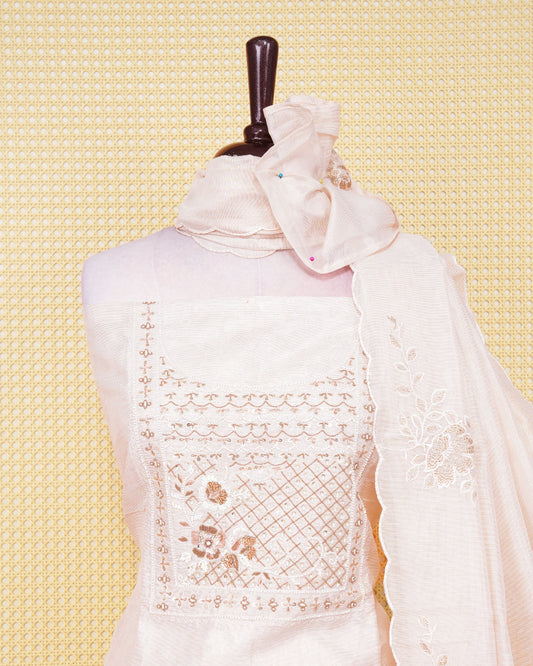 Cream  colour tissue salwar material featuring an elegant floral pattern on body, beadwork on chest portion, paired with a matching bottom and an elegant dupatta.