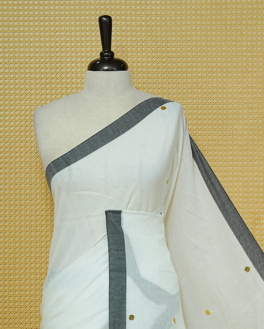 White colour Mul cotton saree featuring Gold Sequins, complemented by Contrast Black simple Border & tassels.