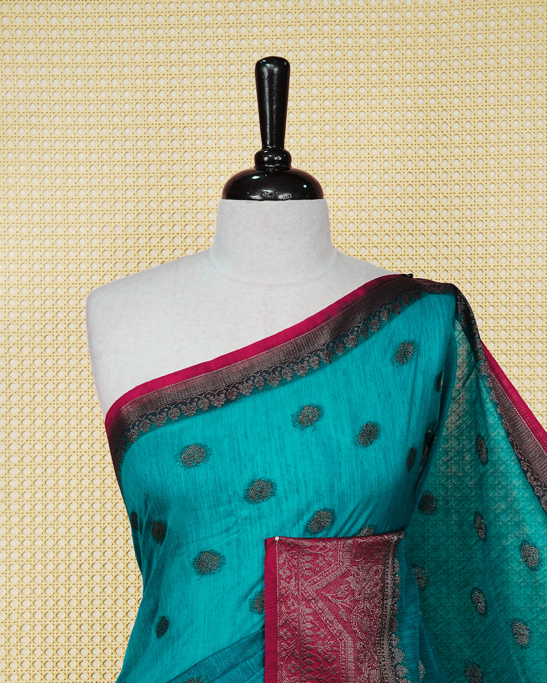 Dark teal colour semi linen saree thread motifs on body, contrast dark pink colour gold zari border, rich pallu comes with matching blouse piece