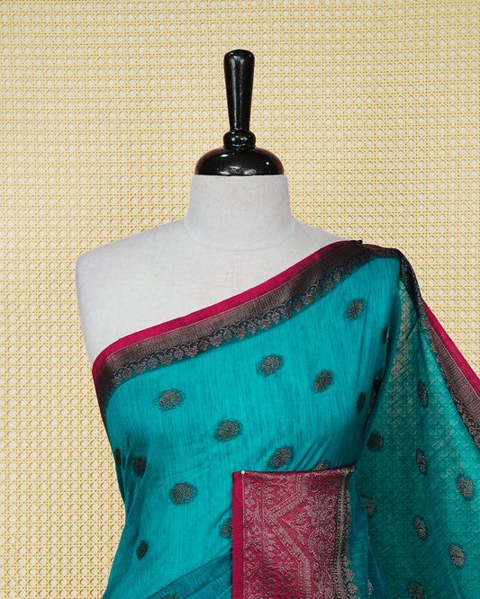 Dark teal colour semi linen saree thread motifs on body, contrast dark pink colour gold zari border, rich pallu comes with matching blouse piece