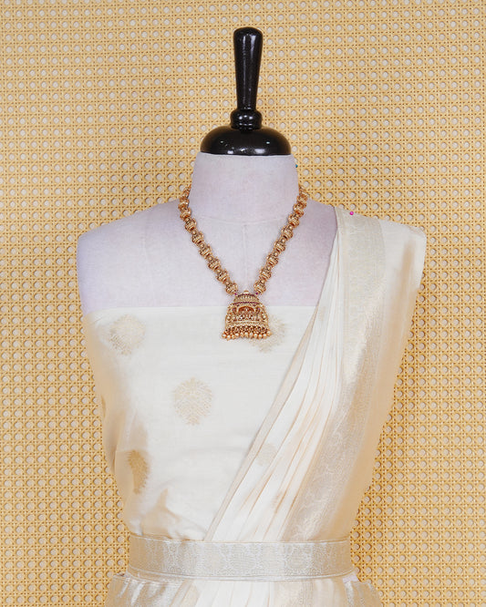 Cream coloured semi silk semi stitched dhavani set featuring gold zari Motifs on the body with a matching gold zari bordered skirt & blouse piece and dupatta.