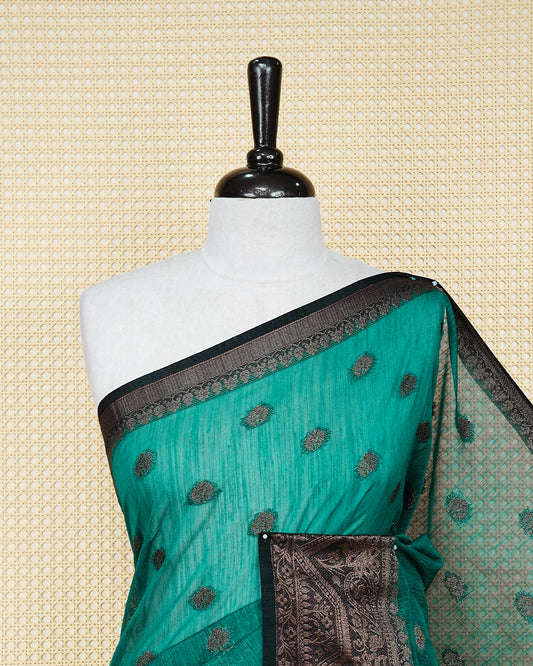 Bottle green colour semi linen saree thread motifs on body, contrast black colour gold zari border, rich pallu comes with matching blouse piece