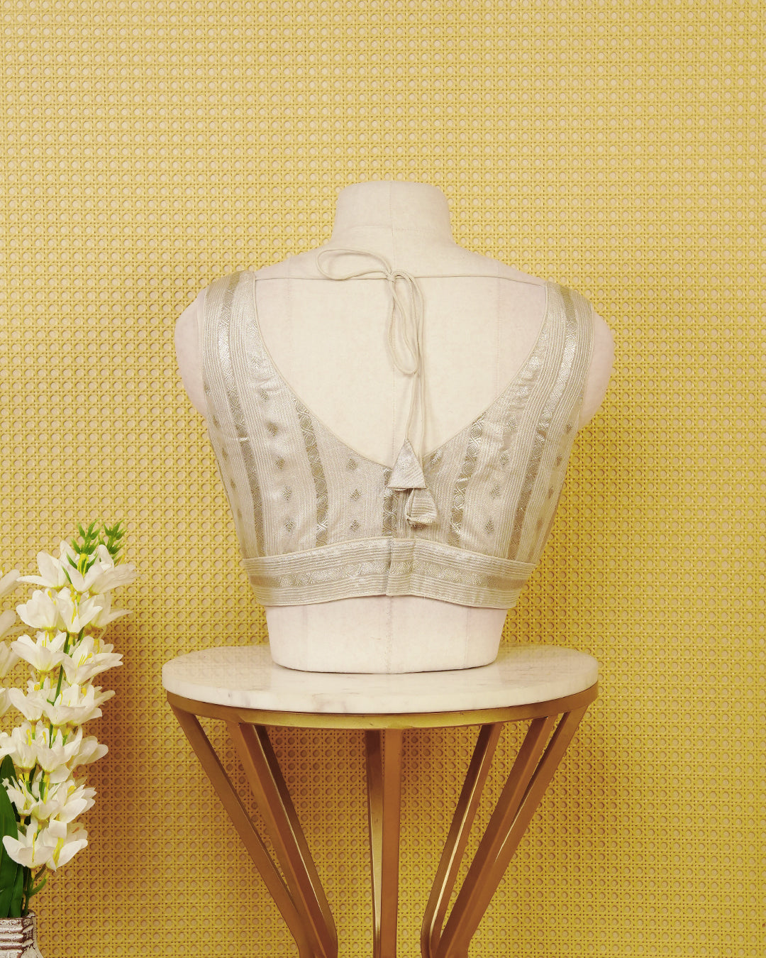 Silver colour Sleeveless Blouse Featuring A Stylish V-Neck, Elegant Woven Zari Stripes With Butta Motifs, And A Comfortable Tailored Fit.