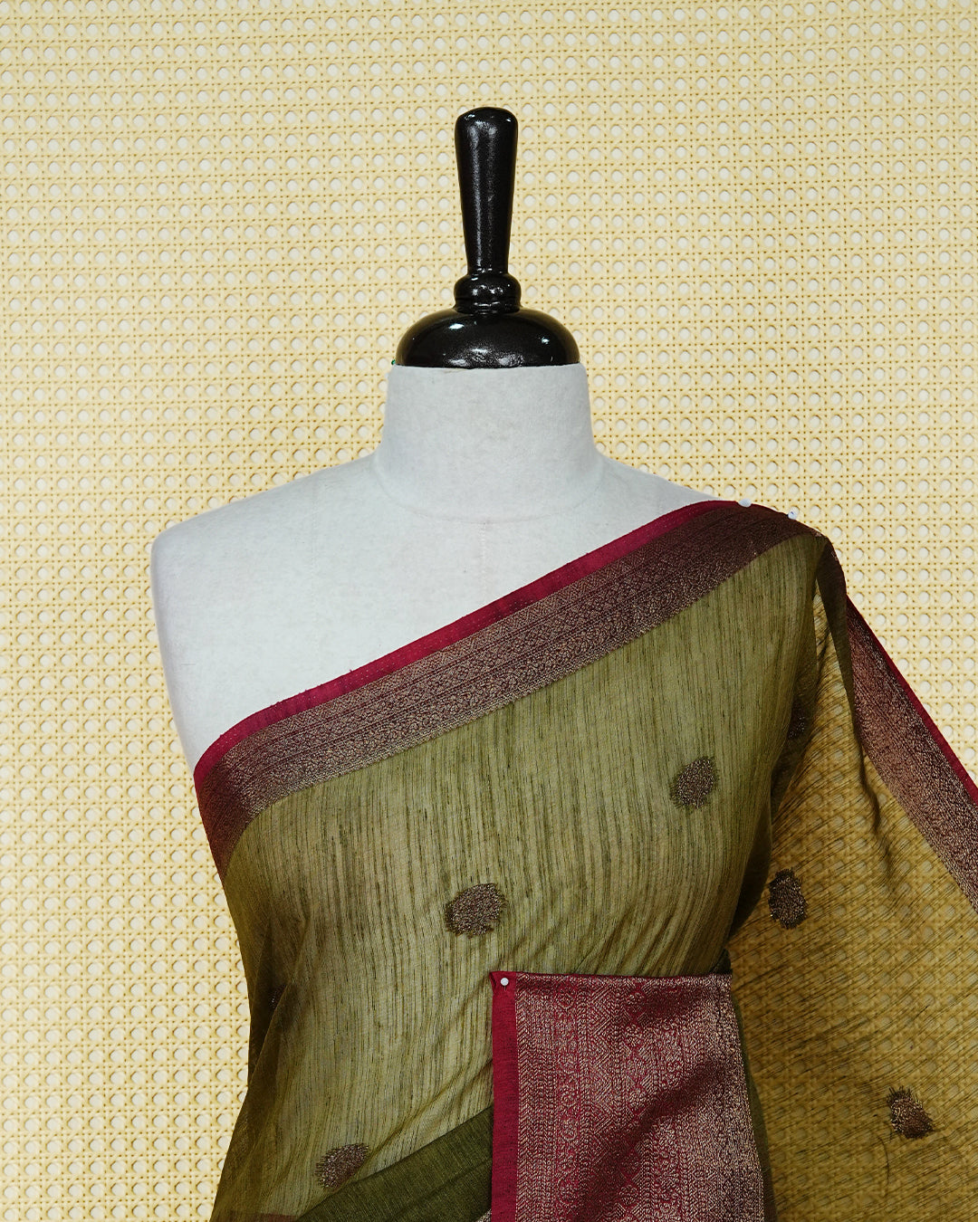 Dark olive colour semi linen saree thread motifs on body, contrast wine colour gold zari border, rich pallu comes with matching blouse piece