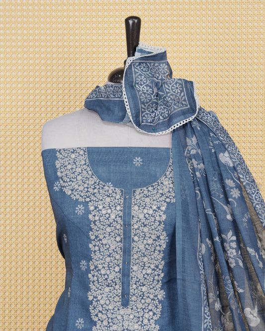 Dusty Blue colour Net kota salwar material featuring elegant Threadwork on neck portion & floral prints on body, paired with a matching bottom and an elegant dupatta.