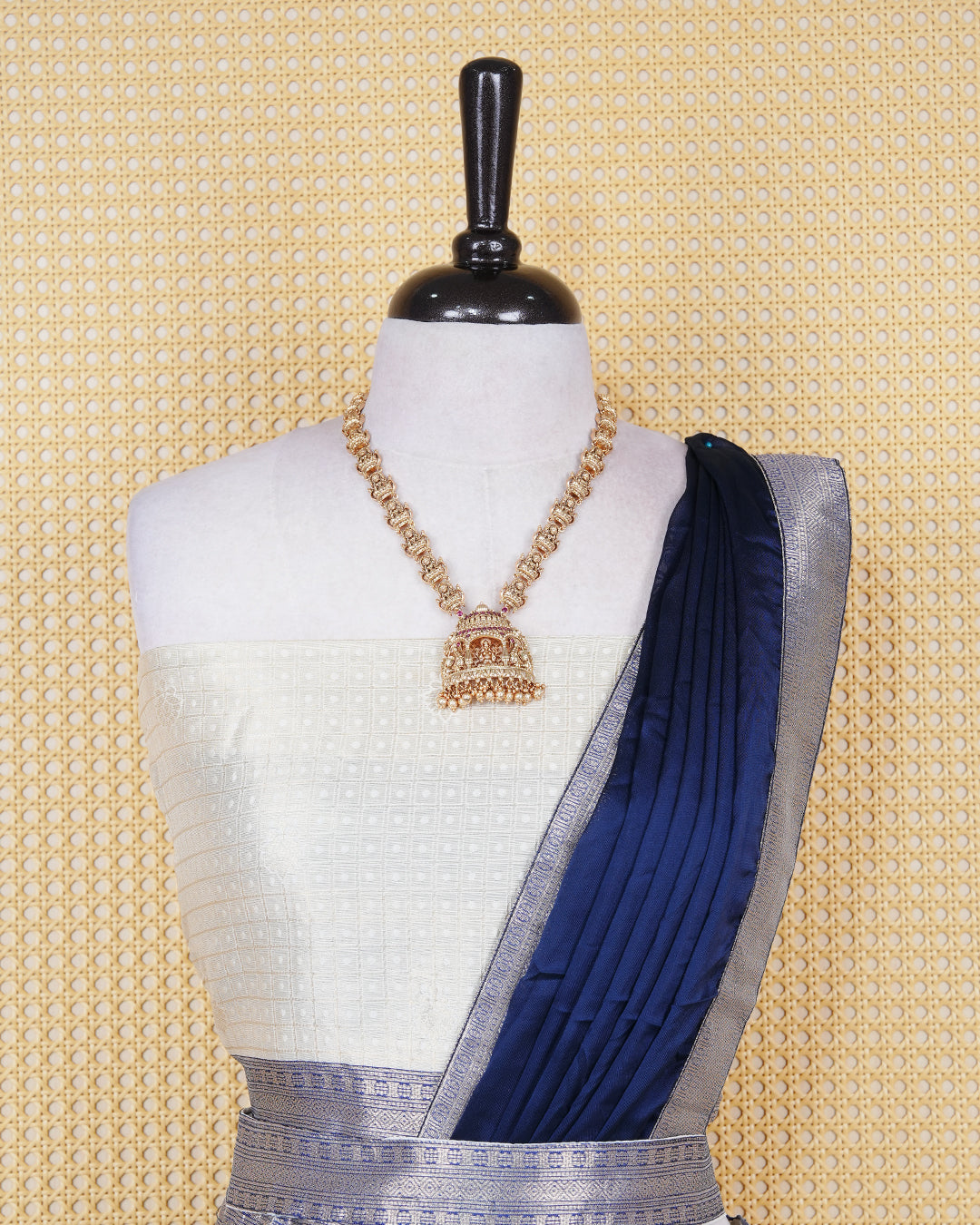Cream colour tissue Semi stitched dhavani set featuring Gold zari check pattern with motifs on body ,contrast Blue colour with gold zari bordered skirt, paired with matching blouse piece & dupatta.
