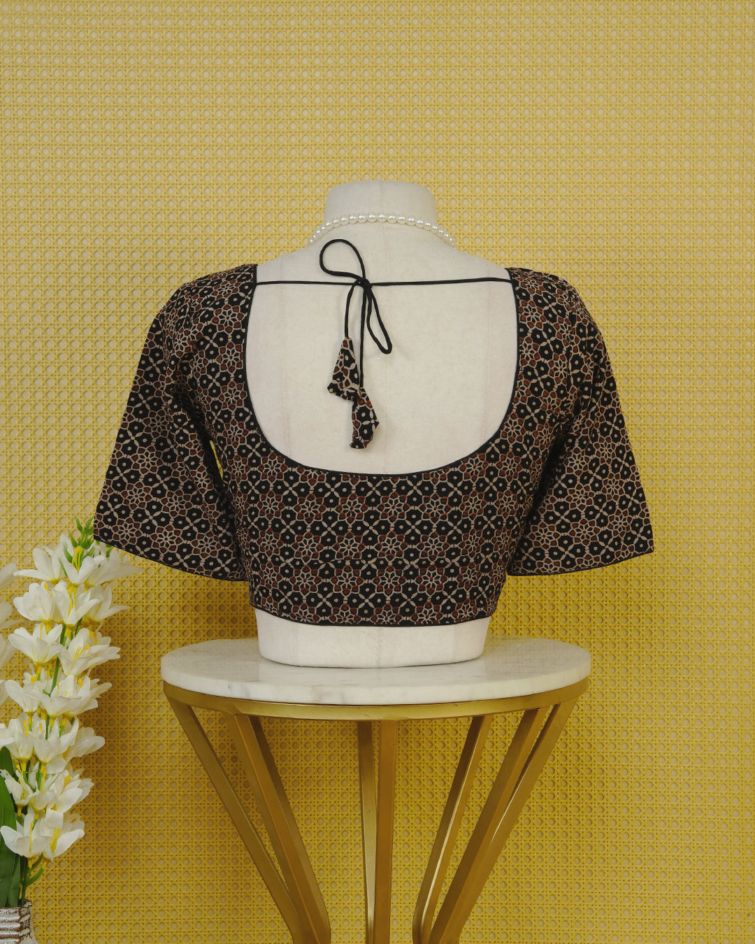 Black Colour Blouse Featuring A Classic U-Neck, Intricate Floral Geometric Print, And Comfortable Elbow Length Sleeves.