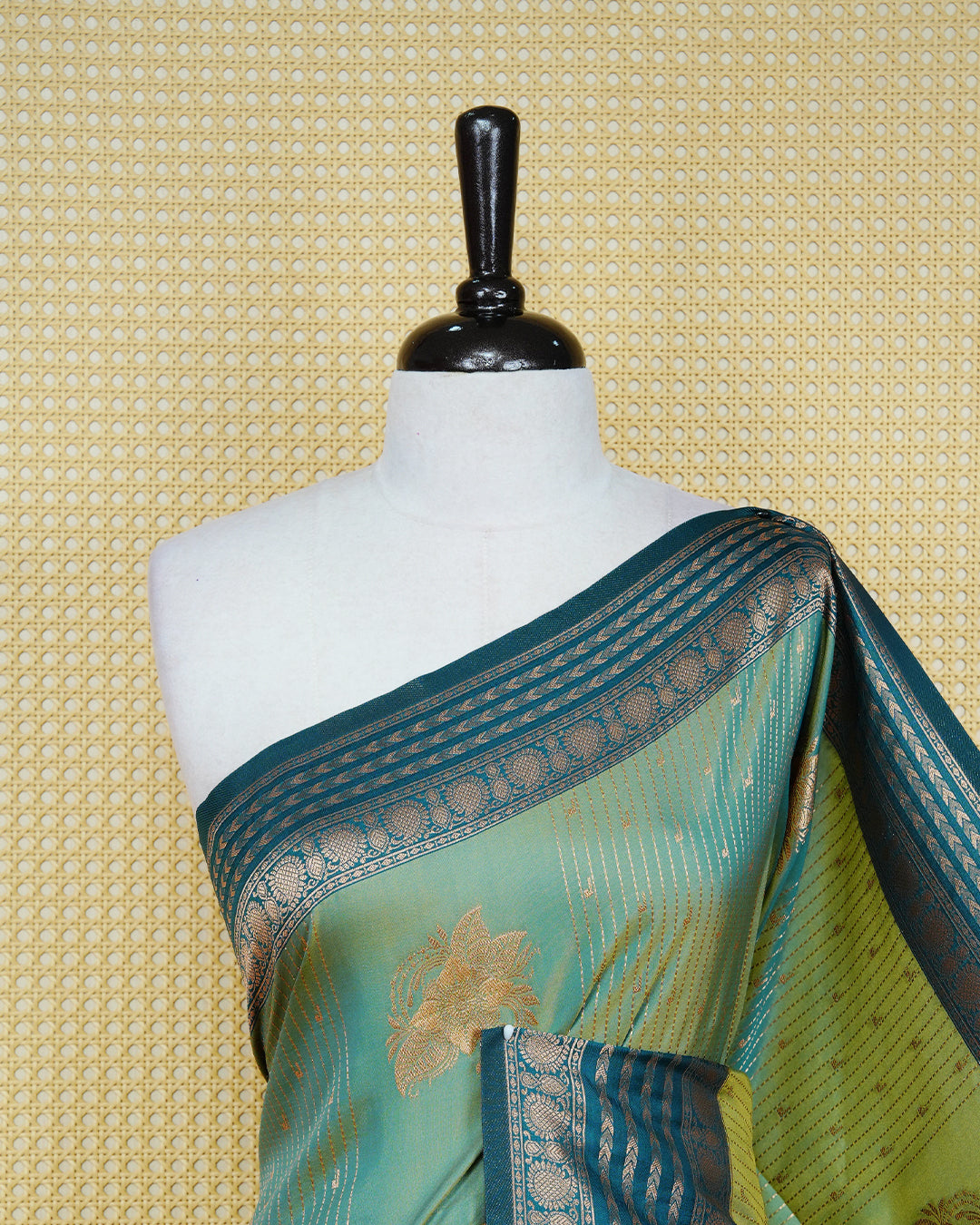 Green & gold double shade Mulberry silk saree featuring gold floral zari patterns on body , paired with contrast bottle green colour with traditional border, comes with matching blouse piece.