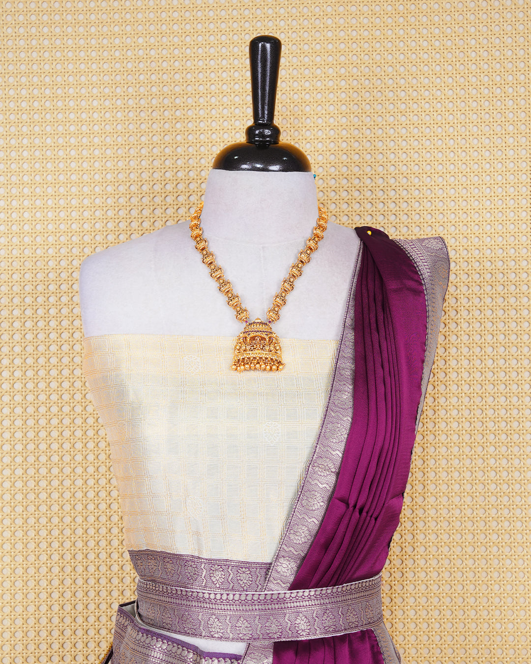 Cream colour  tissue  Semi stitched dhavani set featuring Gold zari check pattern on body ,contrast Purple colour with gold zari bordered skirt, paired with matching blouse piece & dupatta.