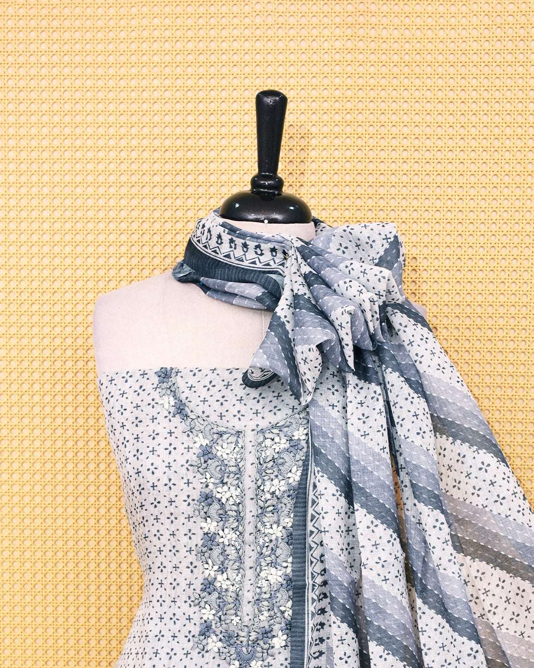 Cream colour Linen Salwar Material with  Printed body ,delicate floral embroidery on yoke, paired with a solid slate grey bottom and a beautifully striped printed dupatta with tassel detailing