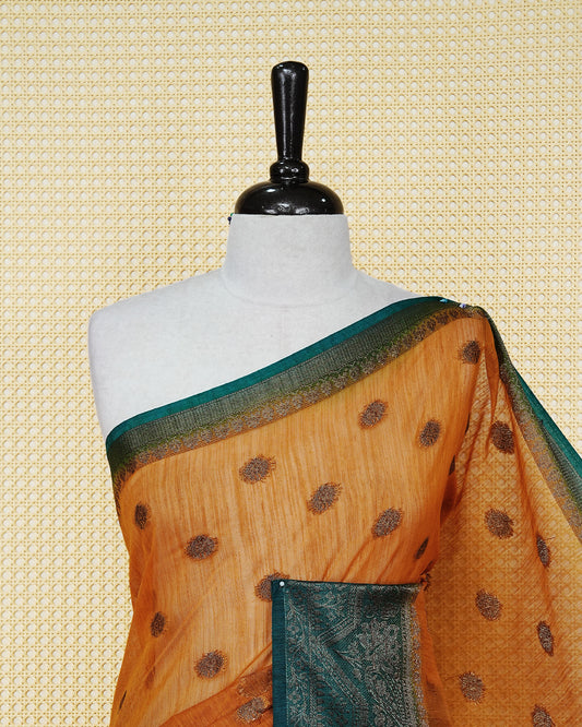 Mustard yellow colour semi linen saree thread motifs on body, contrast dark teal colour gold zari border, rich pallu comes with matching blouse piece