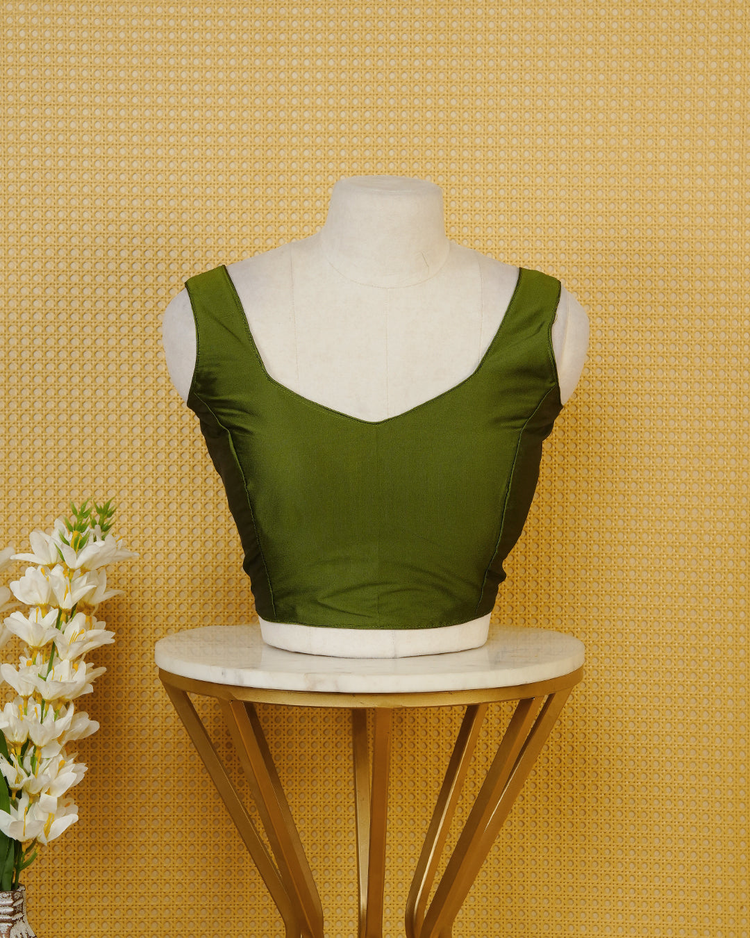 Green colour Sleeveless Blouse Featuring A Stylish Sweetheart Neck, Smooth Finish, And A Comfortable Tailored Fit.
