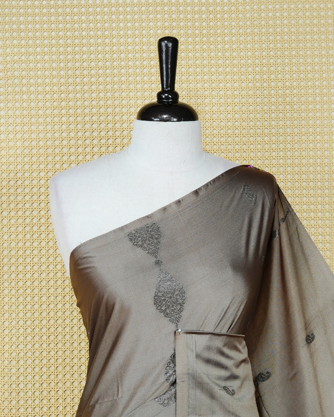 Taupe beige colour soft silk saree featuring antique zari motifs on body with contrast dark maroon colour pallu & paired with matching blouse piece.