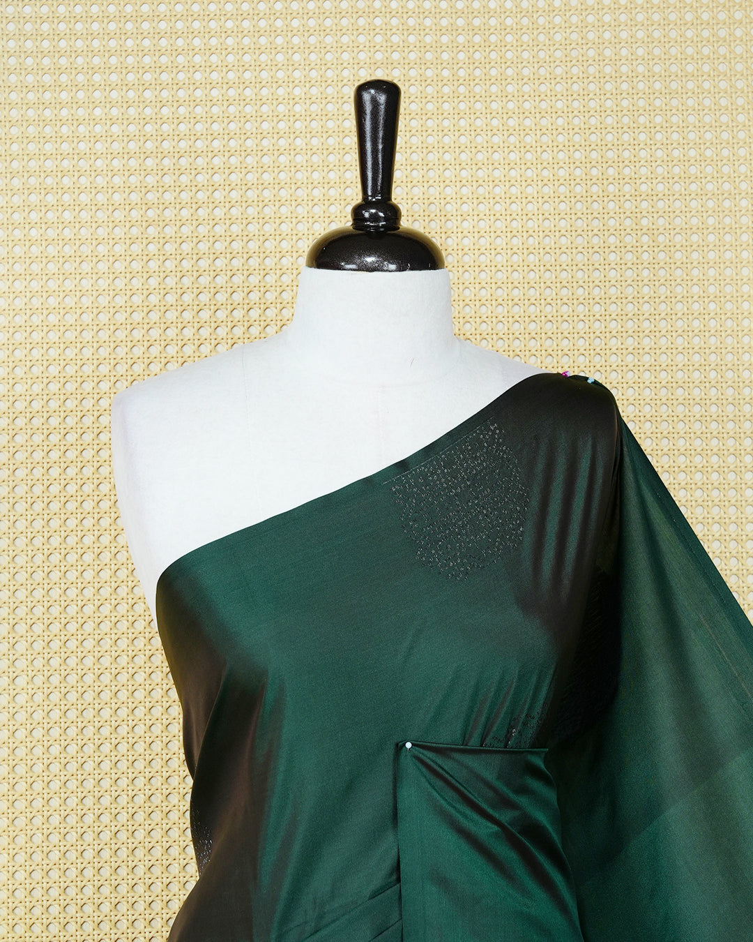 Dark forest green colour soft silk saree featuring antique zari motifs on body with contrast self colour pallu & paired with matching blouse piece.