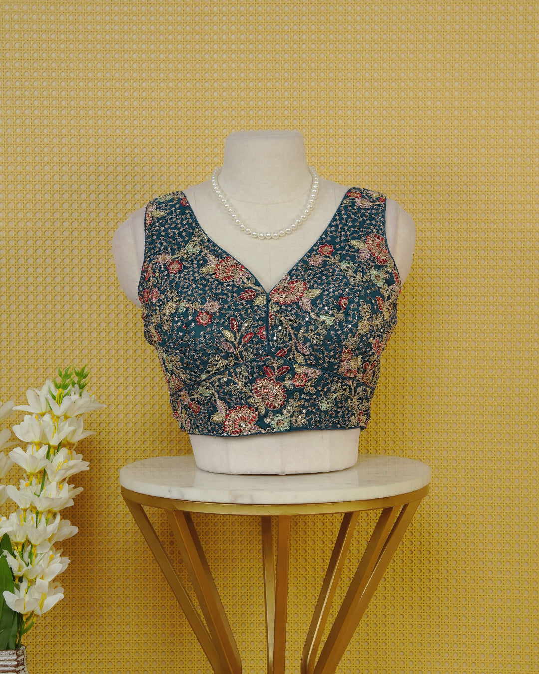 Blue colour Embroidered Sleeveless Blouse Featuring A Stylish V-Neck, Intricate Floral Embroidery With Sequin Detailing, And A Comfortable Tailored Fit.