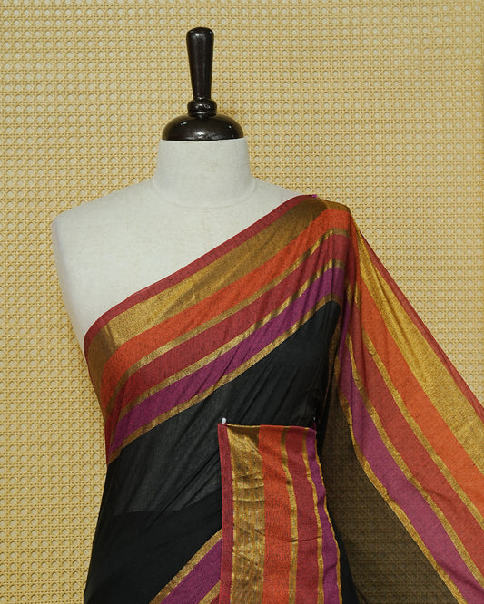 Black  Colour Mul Cotton Saree with a plain black body and a multicolour zari striped border in rust, magenta, and gold & Magenta , Orange Tassels