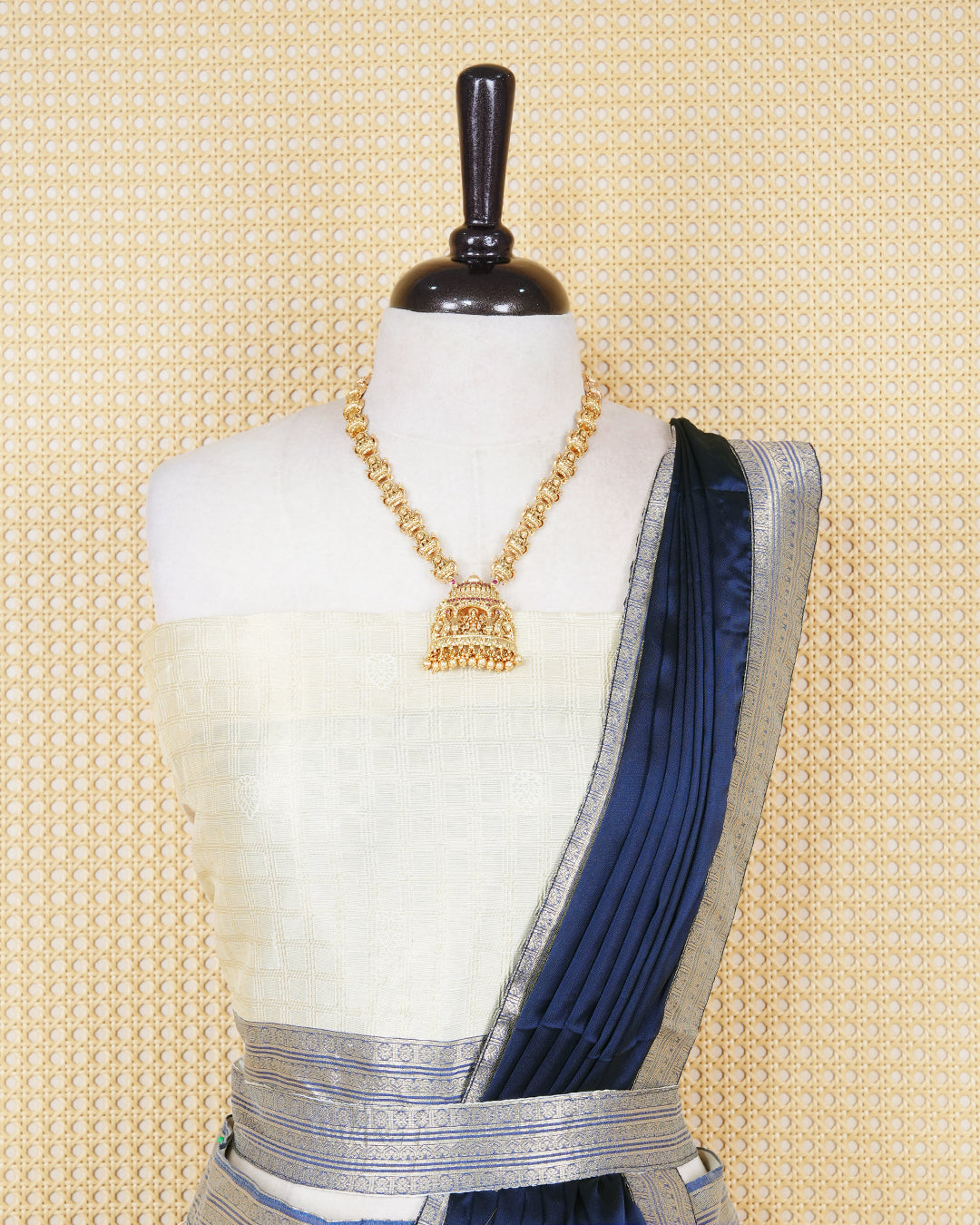 Cream colour tissue Semi stitched dhavani set featuring Gold zari check pattern with motifs on body ,contrast Blue colour with gold zari bordered skirt, paired with matching blouse piece & dupatta.