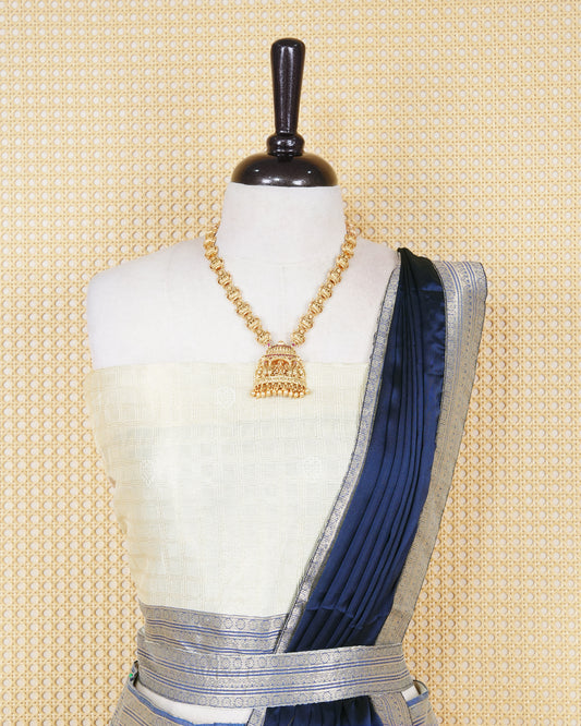 Cream colour tissue Semi stitched dhavani set featuring Gold zari check pattern with motifs on body ,contrast Blue colour with gold zari bordered skirt, paired with matching blouse piece & dupatta.