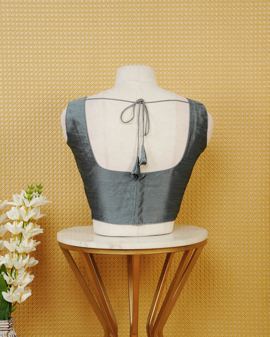 Steel Grey colour Sleeveless Blouse Featuring A Classic Scoop Neck, Smooth Finish, And A Comfortable Tailored Fit.