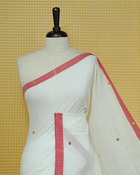 White colour Mul cotton saree featuring Gold Sequins, complemented by Contrast Red simple Border & tassels.