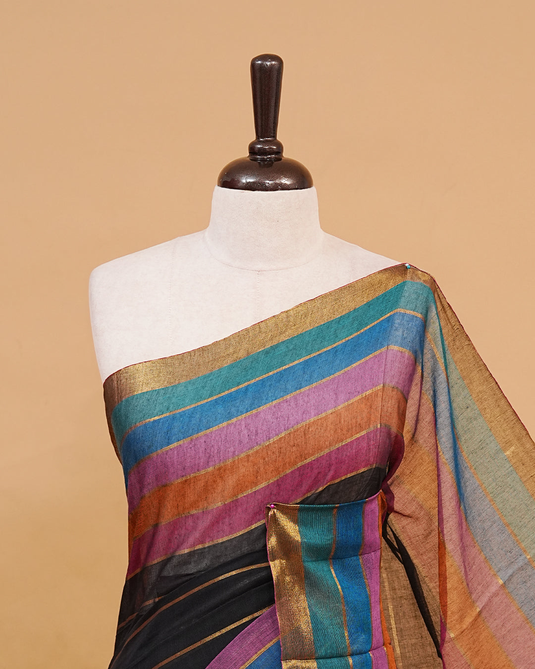 Black colour  mul cotton saree featuring a striped body, vibrant multicolour border, and striped pallu. Comes without a blouse piece.