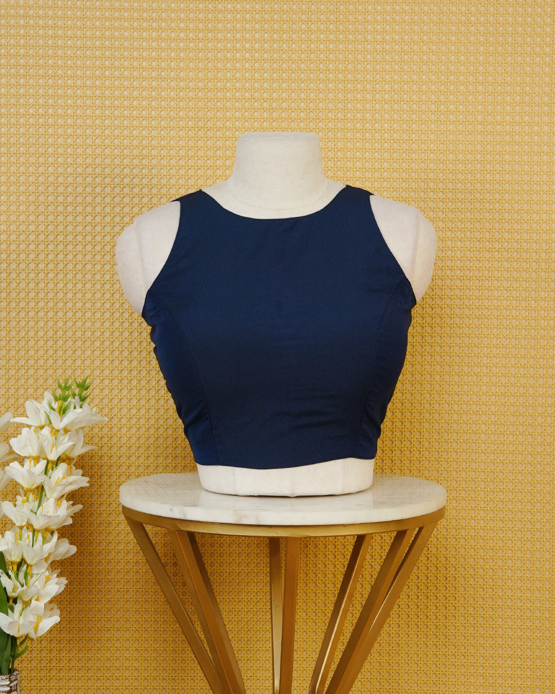 Navy Blue Plain Blouse Featuring A Classic Round Neckline, Sleeveless Design, And A Simple Fitted Silhouette.