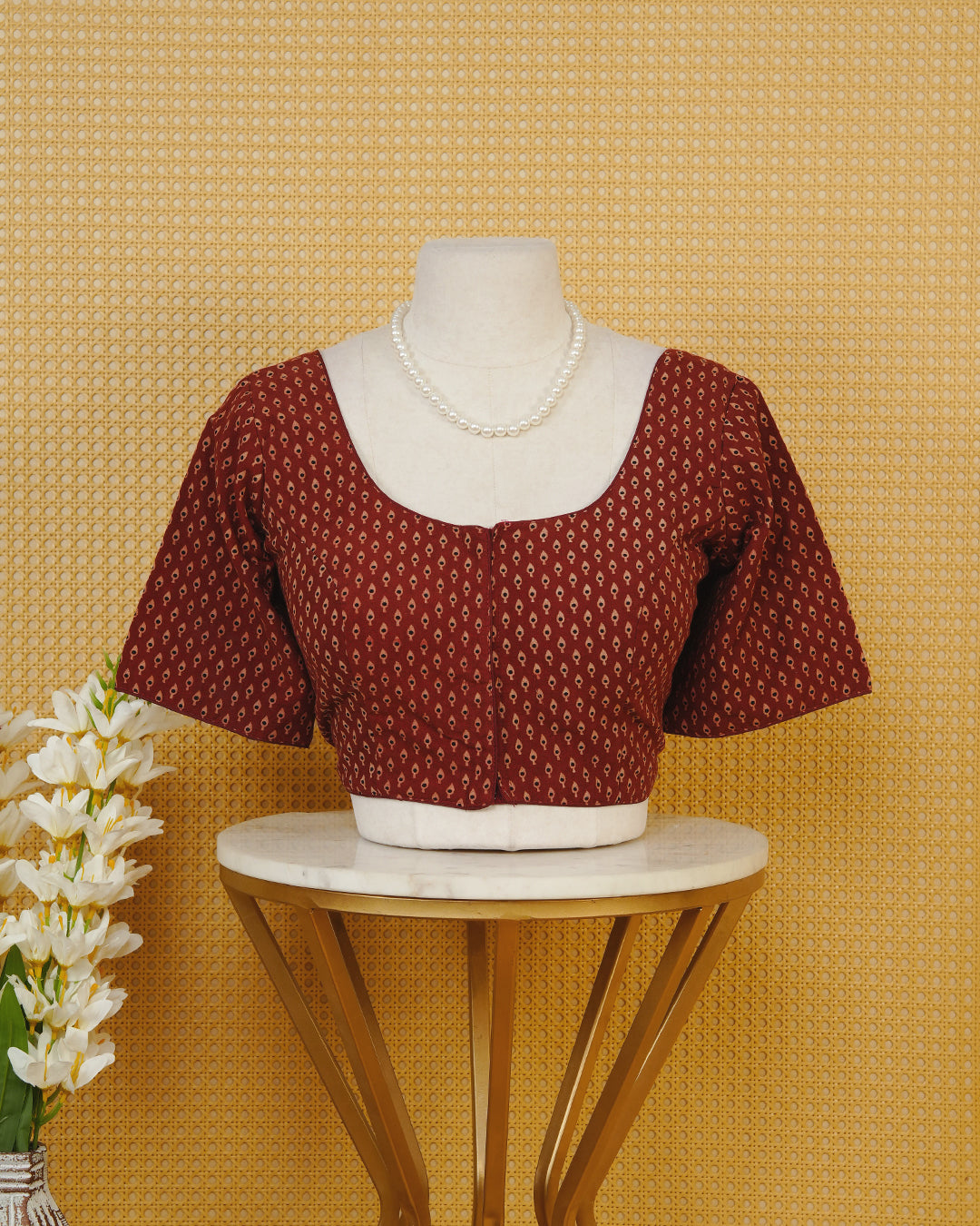 Maroon Colour Printed Blouse Featuring An All Over Small Teardrop Motif Pattern, Enhanced With A Round Neckline, Front Button Closure, And Short Sleeves.