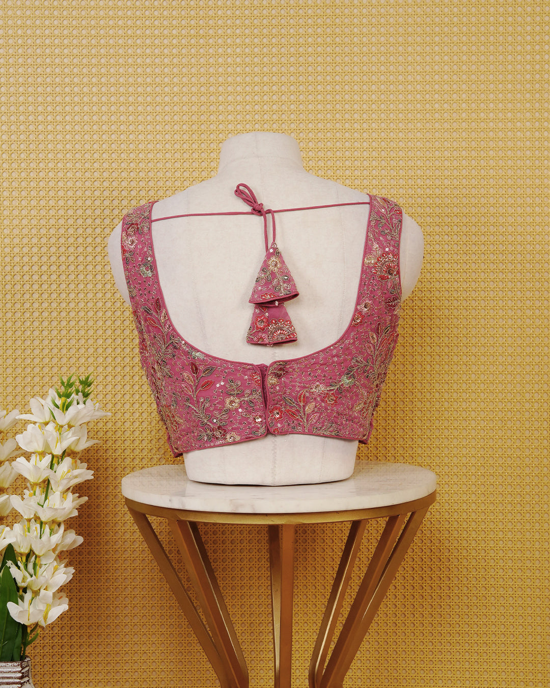 Pink colour Sleeveless Blouse Featuring A Stylish V-Neck, Intricate Floral Embroidery With Sequin Detailing, And A Comfortable Tailored Fit.