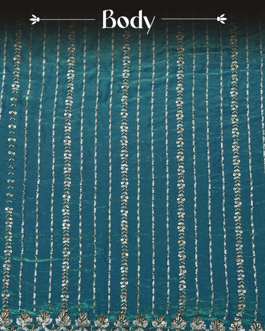 Teal colour Velvet chiffon designer saree featuring Sequins & cut beats strips on body and scallop border, comes with matching blouse piece.