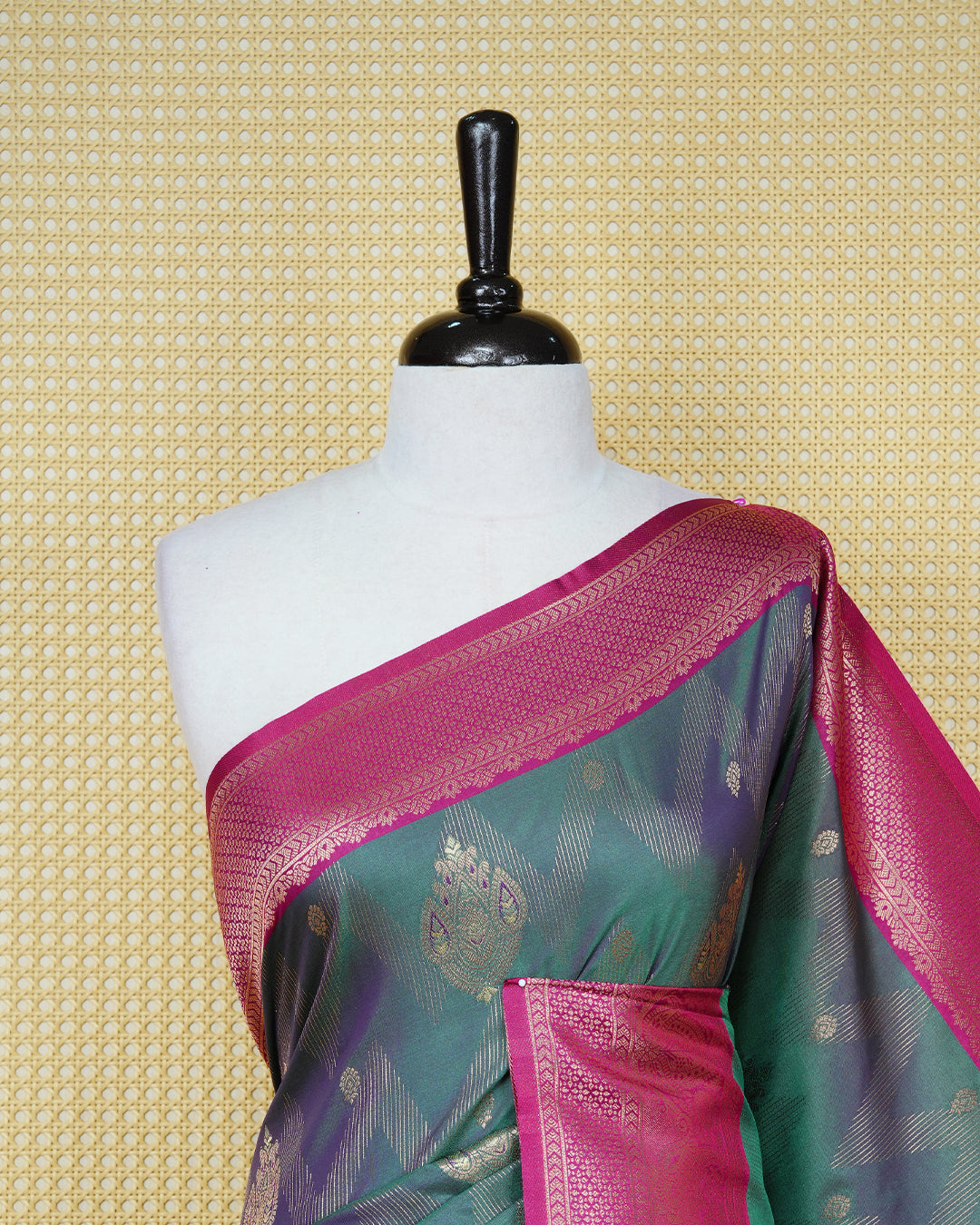 Green colour Mulberry silk saree featuring gold floral zari patterns on body, paired with contrast magenta colour with traditional border, comes with matching blouse piece.