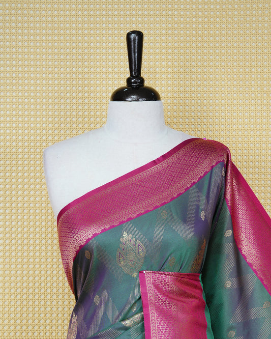 Green colour Mulberry silk saree featuring gold floral zari patterns on body, paired with contrast magenta colour with traditional border, comes with matching blouse piece.