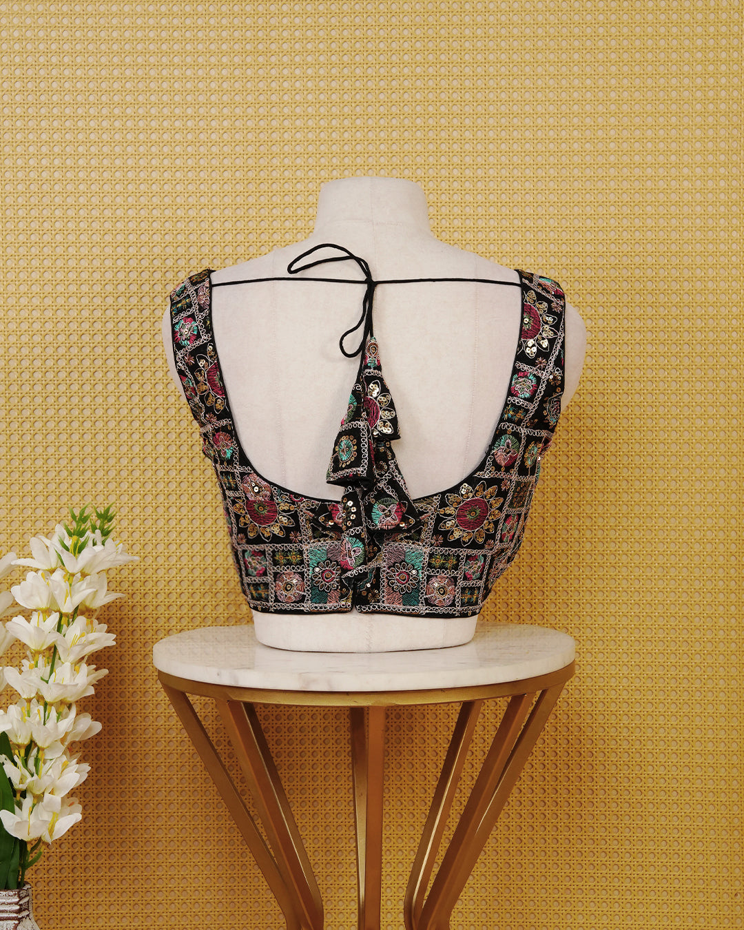 Black colour Sleeveless Blouse Featuring A Classic V-Neck, Intricate Multicolour Embroidery With sequin Detailing, And A Comfortable Tailored Fit