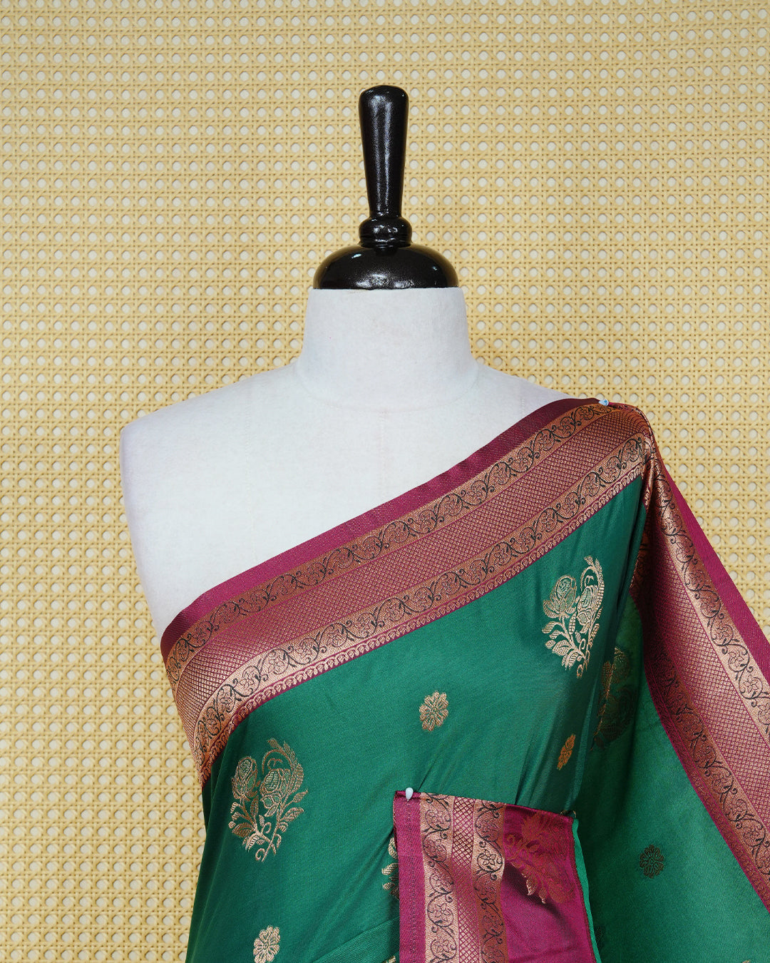 Green colour Mulberry silk saree featuring gold floral zari patterns on body, paired with contrast maroon colour with traditional border, comes with matching blouse piece.