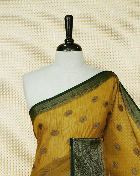 Mustard yellow colour semi linen saree thread motifs on body, contrast Dark green colour gold zari border, rich pallu comes with matching blouse piece