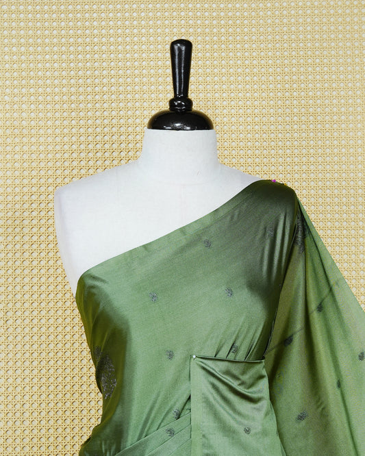 Pastel green colour soft silk saree featuring antique zari motifs on body with contrast self colour pallu & paired with matching blouse piece.